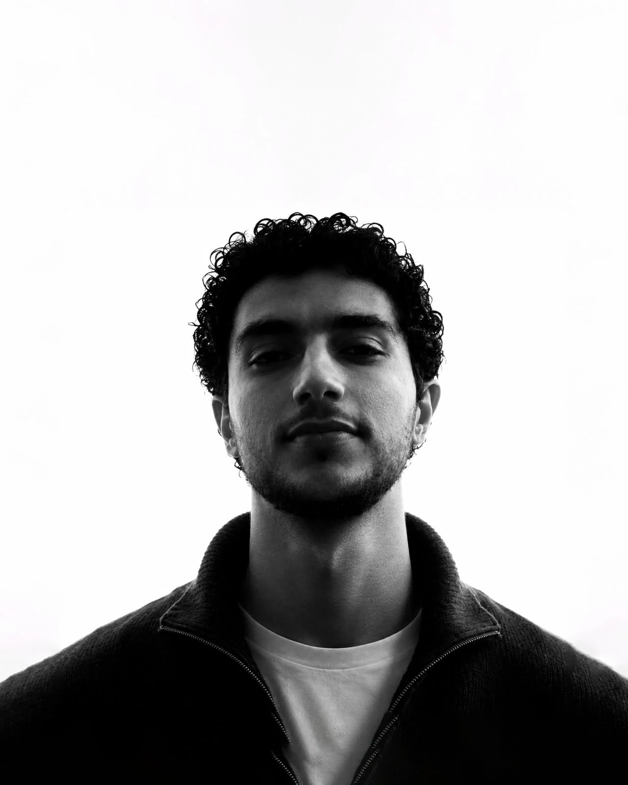Diaa Shehab, art director, black-and-white portrait against a bright sky