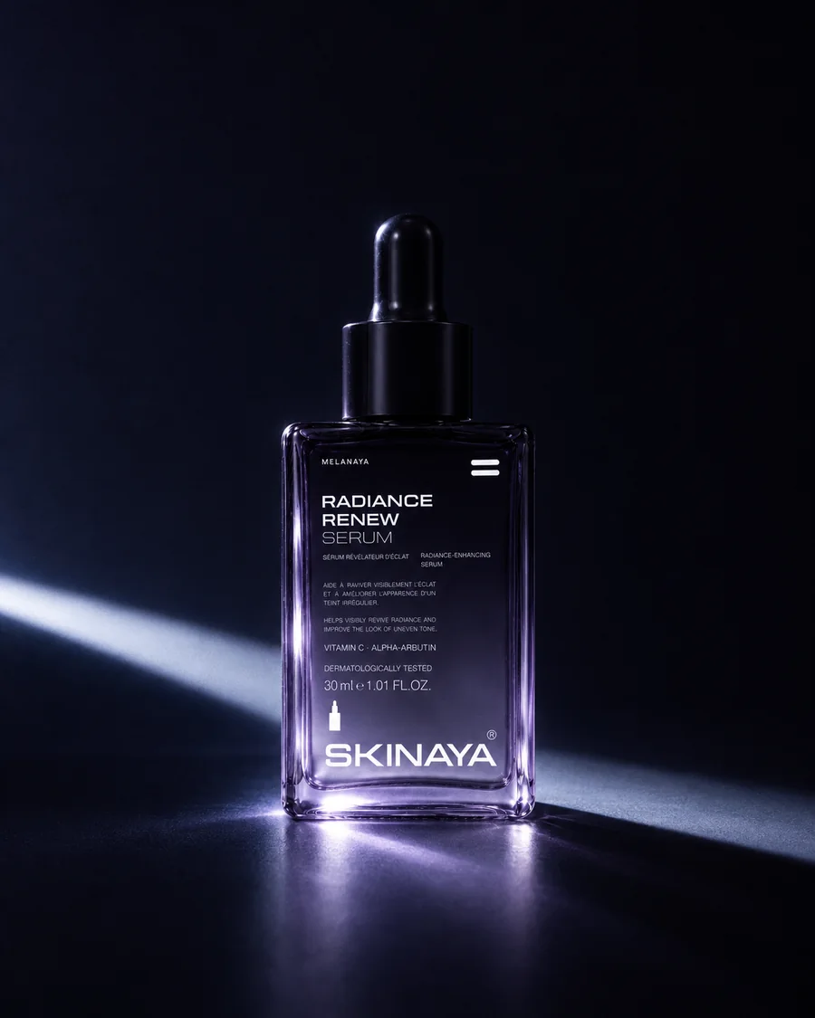 The MELANAYA Radiance Renew Serum in a dark violet studio, lit by a single blade of light