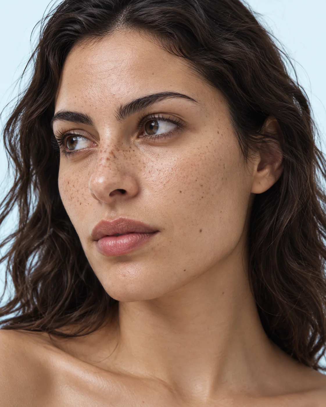 Close portrait of a woman with freckles and bare, unretouched skin